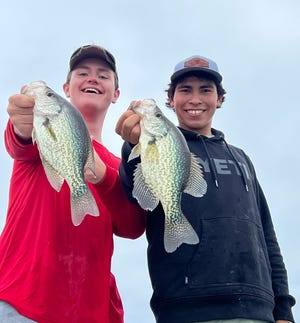 Jack Myers and Brennan Star from Fernandina Beach, FL hold up a pair of really good eating crappie, caught while fishing with Capt. Paul Tyre.