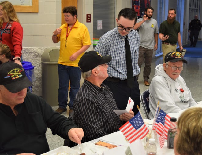West Holmes student Dylan Whitman visits with veterans Jim Wolfe and Bobby Angle during the Veterans Day breakfast hosted by the West Holmes History Club.