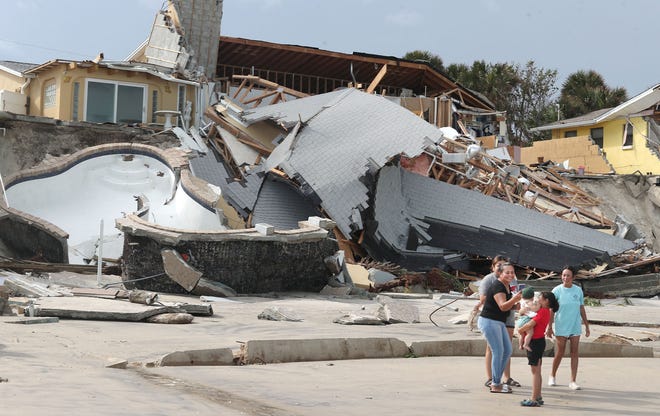 People check out homes in Wilbur-by-the-Sea that sustained damage in Tropical Storm Nicole in November 2022. The deadline to apply for FEMA assistance in connection to Nicole is Feb. 13.