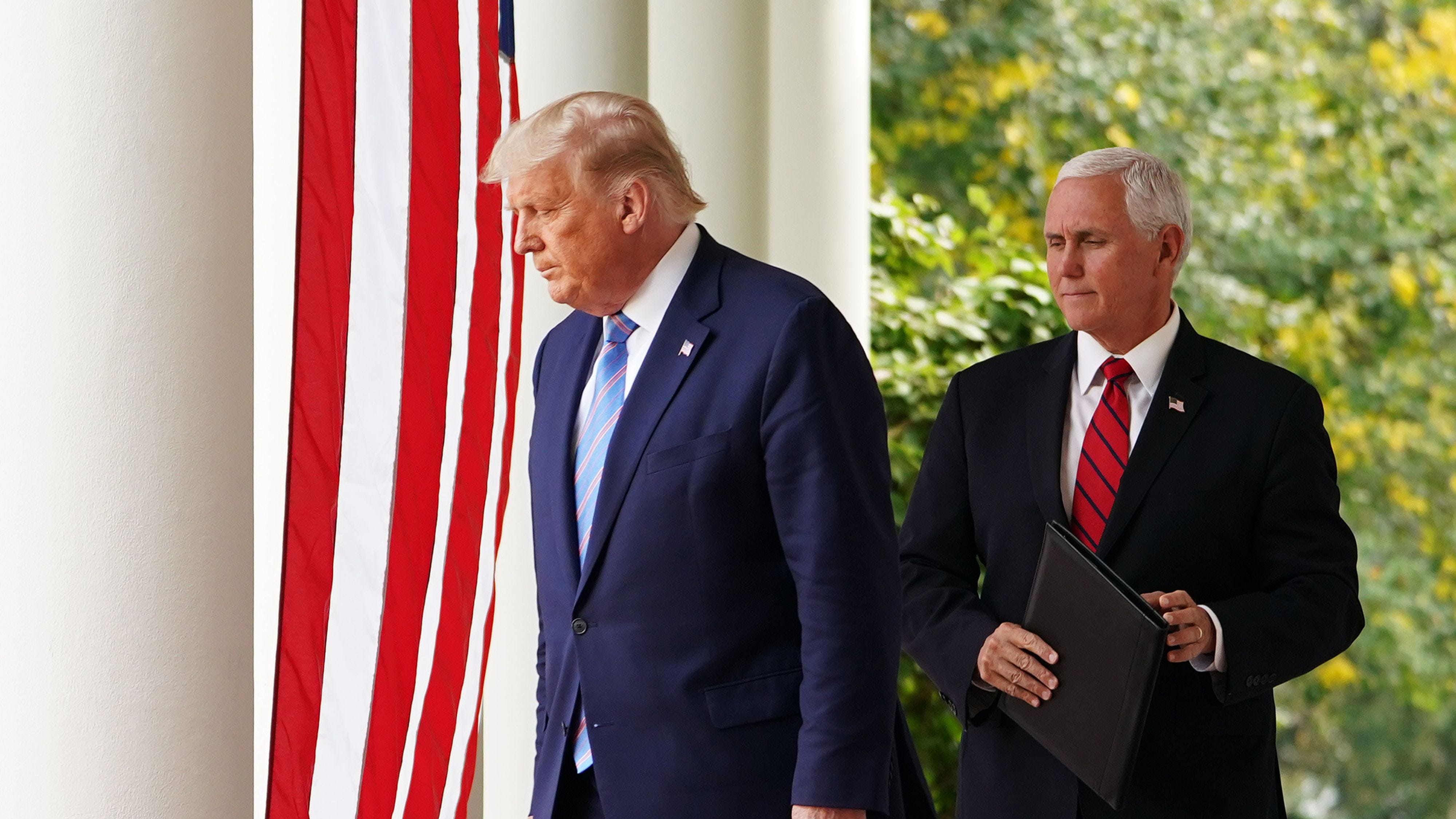 (FILES) In this file photo taken on September 28, 2020, US President Donald Trump and Vice President Mike Pence arrive in the Rose Garden to speak on Covid-19 testing at the White House in Washington, DC. - Pence tested negative on October 2, 2020, for Covid-19, his spokesman said after President Donald Trump announced he and First Lady Melania Trump had contracted the coronavirus. "As has been routine for months, Vice President Pence is tested for Covid-19 every day. This morning, Vice President Pence and the Second   Lady tested negative for Covid-19," spokesman Devin O'Malley tweeted. (Photo by MANDEL NGAN / AFP) (Photo by MANDEL NGAN/AFP via Getty Images) ORG XMIT: 0 ORIG FILE ID: AFP_8R98LG.jpg