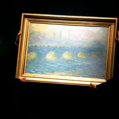 Two staff hang a Claude Monet 1904 painting 'Water