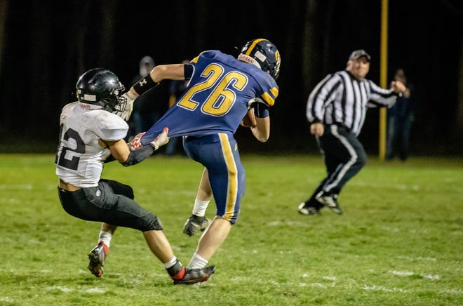 Whiteford’s Jake Iott tries to pull away from a defender during a 38-26 win over White Pidgeon in a Division 7 Regional championship game Friday night.