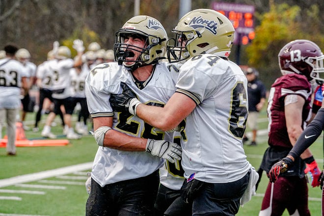Andrew Ciarniello celebrates with teammate Jakob Beaupre, after scoring scores to make it 21-20, before tying with point after in second half action
