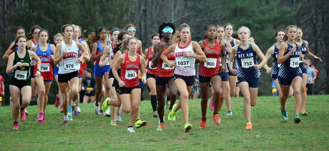 North Hagerstown sophomore Lauren Stine (1037) leads a pack of runners at the start of the Class 3A girls race in the Maryland state cross country championship at Hereford High School on Nov. 12, 2022. Stine finished second.