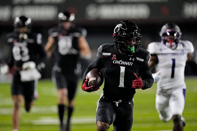Cincinnati Bearcats wide receiver Tre Tucker (1) runs in a catch for a touchdown in the second quarter of the NCAA American Athletic Conference game between the Cincinnati Bearcats and the East Carolina Pirates at Nippert Stadium in Cincinnati on Friday, Nov. 11, 2022.