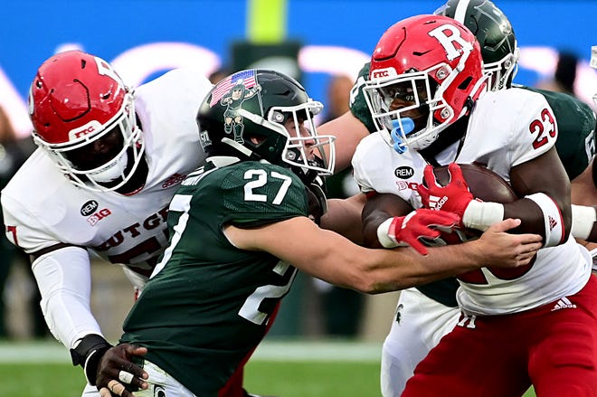 Michigan State Spartans linebacker Cal Haladay tackles Rutgers Scarlet Knights running back Kyle Monangai at the line of scrimmage in the first half at Spartan Stadium, Nov. 12, 2022.