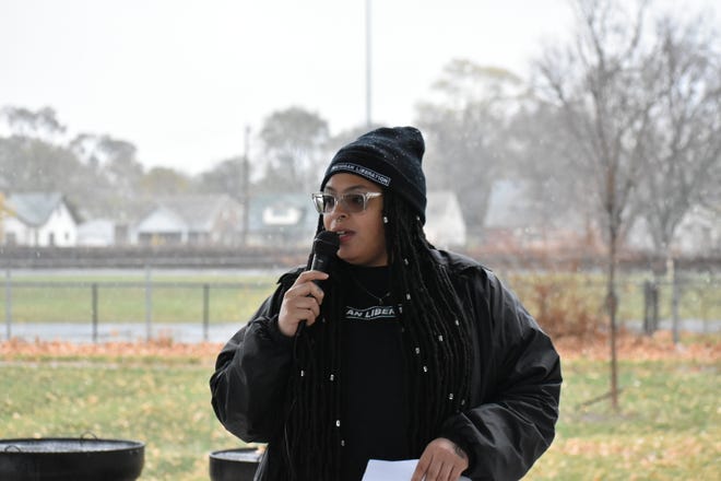 Ash Daniels, lead organizer of the Care Not Criminalization Campaign with Michigan Liberation, speaks to a crowd of around 30 people at a rally Saturday.