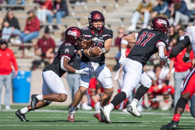 NMSU quarterback Diego Pavia hands off the ball to running back Tim Gans during a NMSU football game on Saturday, Nov. 12, 2022, at the Aggie Memorial Stadium.  