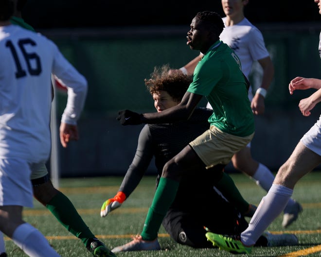 McKay's Abdoulie Jallow (9) scores a goal against West Albany's Jaxon Walker (99) during the first half of the 5A state championship game at Hillsboro Stadium in Hillsboro, Ore. on Saturday, Nov. 12, 2022.