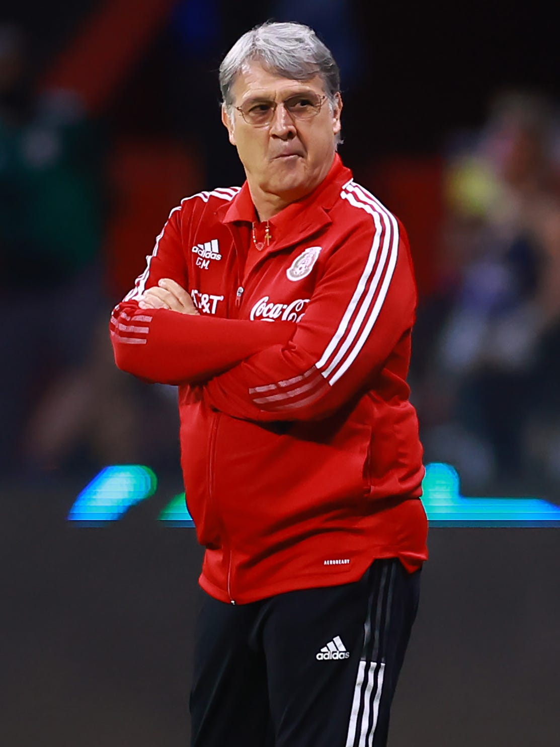 An action image of Gerardo "Tata" Martino coaching soccer.