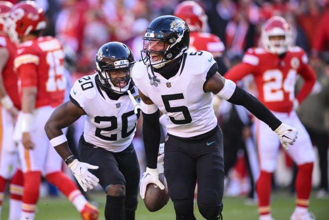 Jacksonville Jaguars safety Andre Cisco (5) celebrates his touchdown against the Kansas City Chiefs with teammate Jaguars safety Daniel Thomas (20) during the second half of an NFL football game against the Kansas City Chiefs, Sunday, Nov. 13, 2022 in Kansas City, Mo. (AP Photo/Reed Hoffmann)