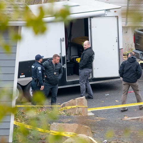 Officers investigate a homicide at an apartment co