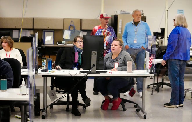 Ballots from Maricopa County voters are adjudicated at the Maricopa County Tabulation and Election Center in Phoenix, Ariz., on Nov. 14, 2022.