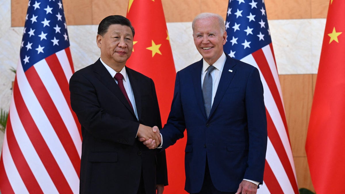 US President Joe Biden (R) and China's President Xi Jinping (L) shakes hands as they meet on the sidelines of the G20 Summit in Nusa Dua on the Indonesian resort island of Bali on November 14, 2022.