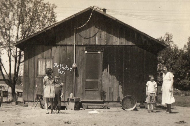 On his 5th birthday, Bob Palmer (second from left) poses in front of his original home on South Jefferson Street in Loudonville next to his sister, Mary Jane Palmer Buzzard. At right are his mother, Clara Josephine "Josie" Palmer, and his mom's younger brother, Alvin Kimball. The Palmers shared this house with a working blacksmith.