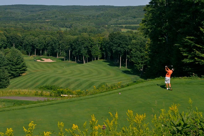 A man golfs at the 13th hole at the Arthur Hills Course at The Highlands in Harbor Springs.
