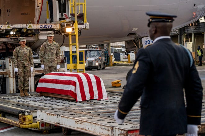 The remains of Lt. John Heffernan, a WWII American bomber navigator who was shot down in Burma in 1944, arrive at Newark Liberty Airport on Tuesday, November 15, 2022. Spc.  Chapilliquen and SPC.  Arca with the military unloads Heffernan's flag-draped coffin from the plane.