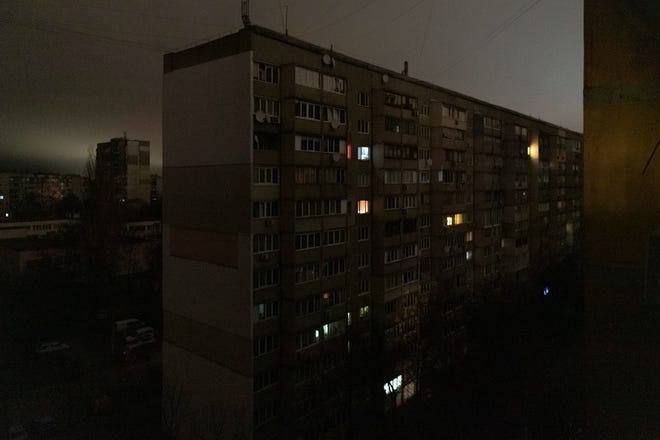 Windows of an apartment building are illuminated during a blackout in central Kyiv, Ukraine, Monday, Nov. 14, 2022.