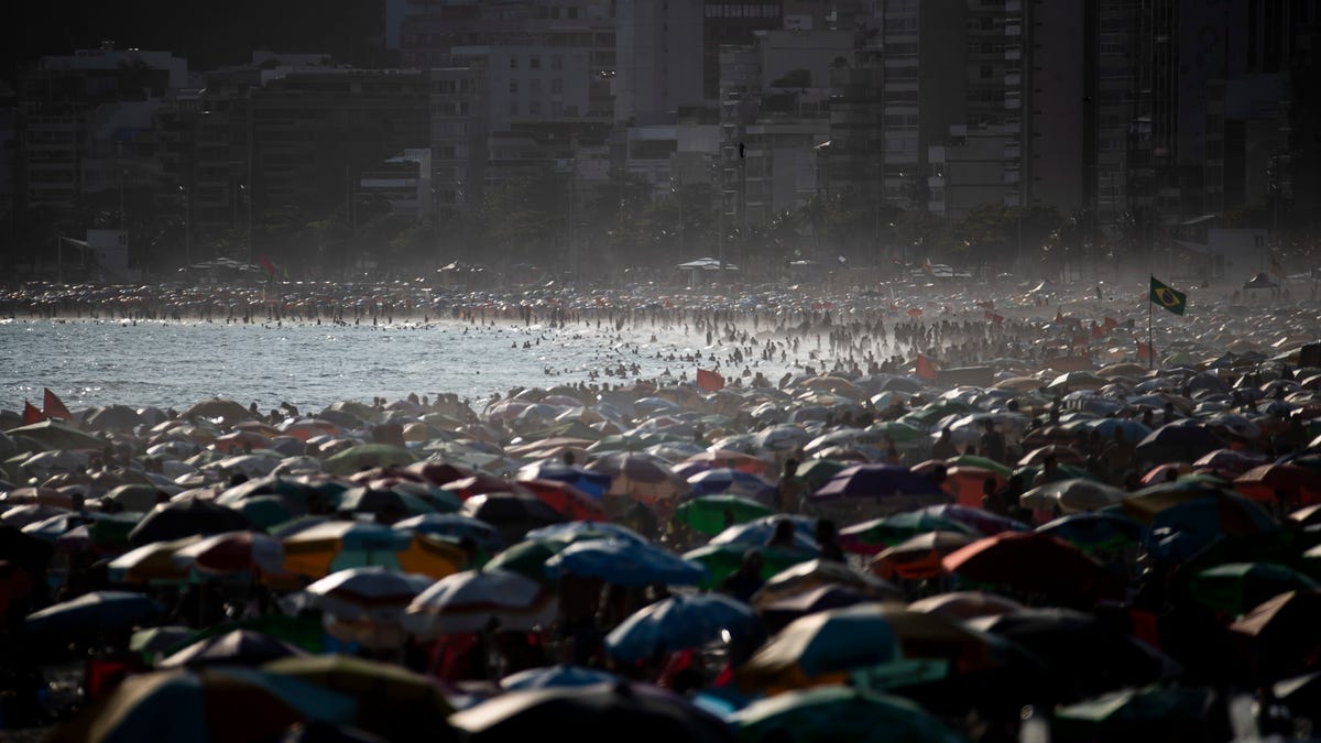 People enjoy the Ipanema beach, in Rio de Janeiro, Brazil, Sunday, Nov.13, 2022. The world's population is projected to hit an estimated 8 billion people on Tuesday, Nov. 15, according to a United Nations projection.