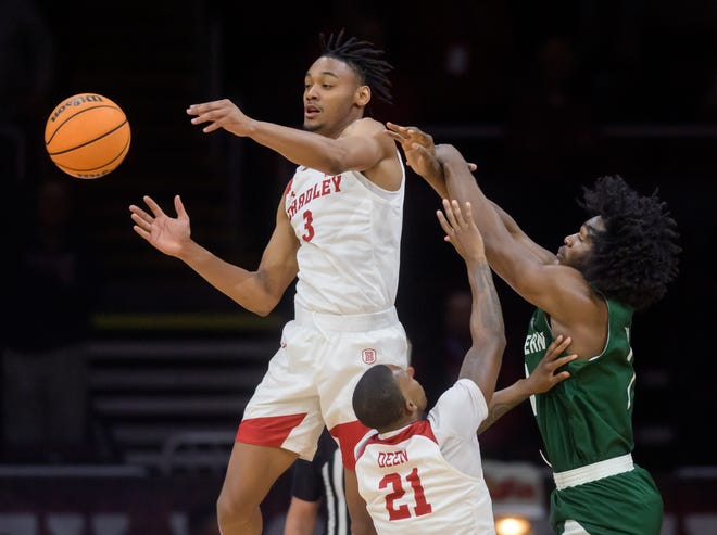 Bradley's Zek Montgomery (3) and Duke Deen (21) knock the ball away from Eastern MIchigan's Colin Gorsin Jr. in the first half Tuesday, Nov. 15, 2022 at the Peoria Civic Center. The Braves trampled the Eagles 89-61.