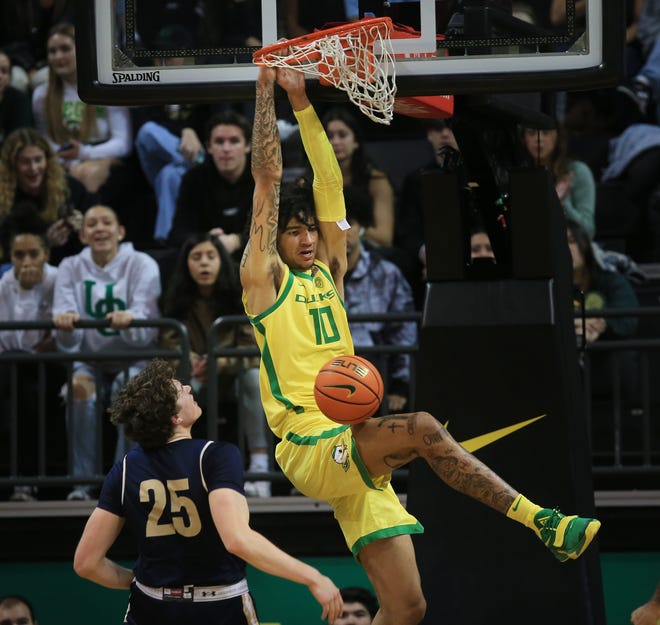 Oregon's Kel'el Ware, right, dunks over Montana State's Sam Lecholat during the first half at Matthew Knight Arena.