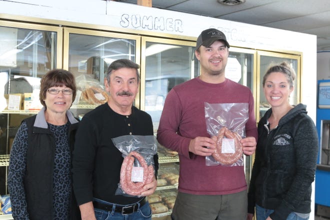 Tilly and Dave Heier stand with Great Frontier Meats owners Tom and Gabrielle Pioske. Great Frontier Meats is now producing a popular Heier Meat product after purchasing the recipe at auction.