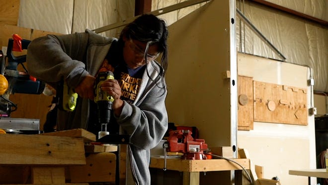 A participant operates a power drill at a Vermont Works for Women workshop on Nov.  11, 2022.