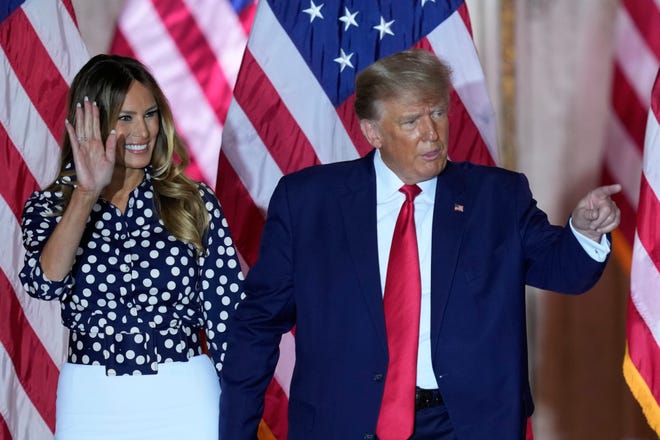 Former President Donald Trump stands on stage with former first lady Melania Trump after announcing a third run for president at Mar-a-Lago in Palm Beach, Fla., Tuesday, Nov. 15, 2022.