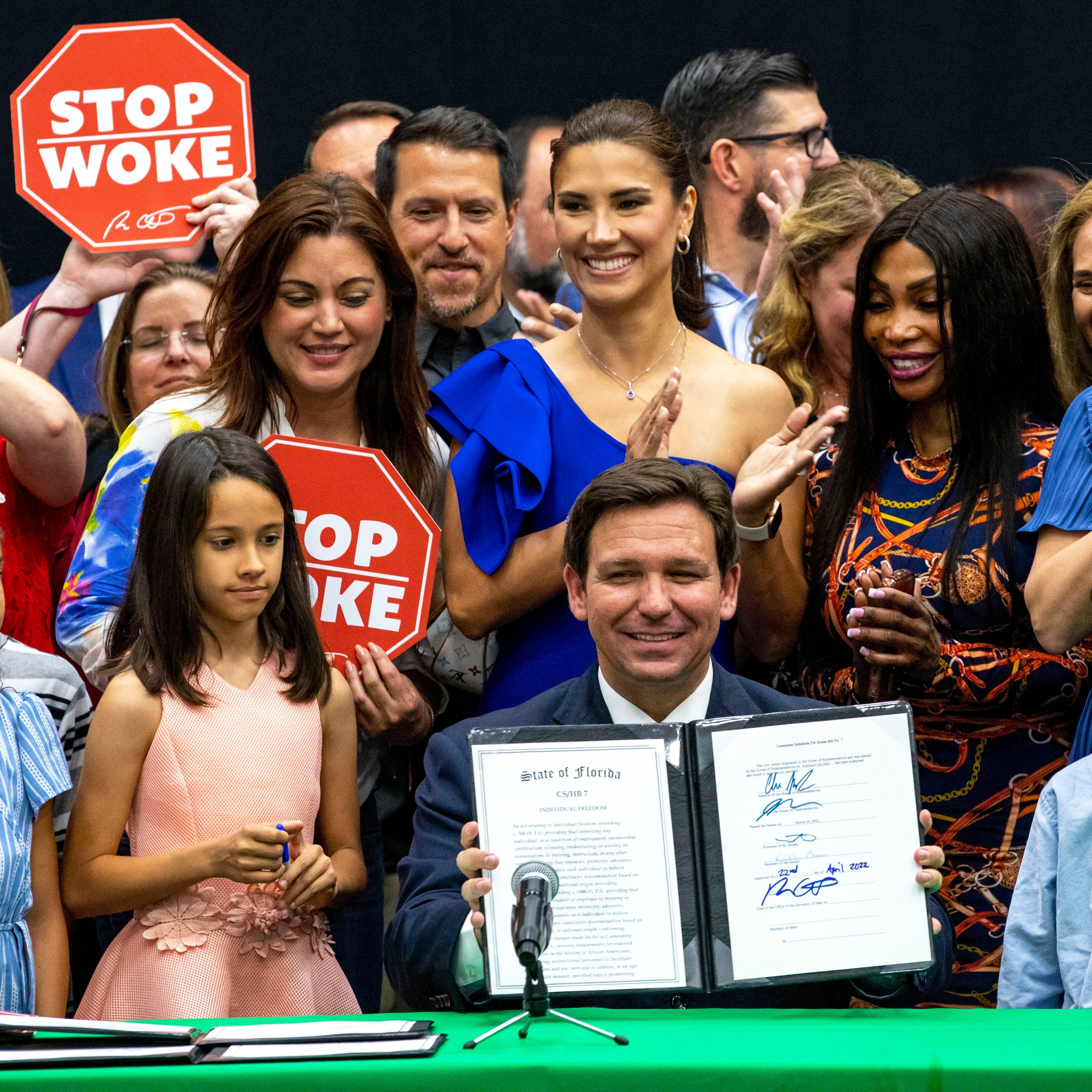 Florida Gov. Ron DeSantis signs the Stop WOKE Act in April 2022.