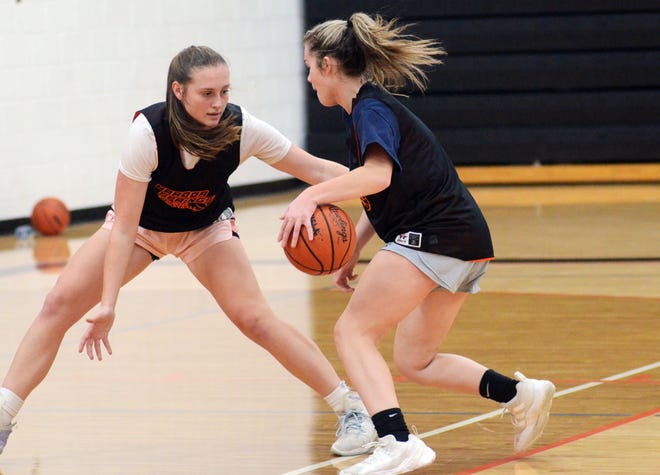 Harbor Springs seniors Sierra Kruzel (left) and Hailey Fisher compete in a drill against each other during Wednesday's practice at Harbor Springs High School.