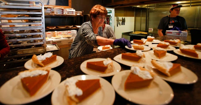 Charlene Bregar of Pittsburg, Mississippi,  sets plates of pumpkin pie on the counter as orders come in at the annual Thanksgiving feast  held at Chuck's Fish in downtown Tuscaloosa on Thursday, Nov. 23, 2017. [Staff file photo]