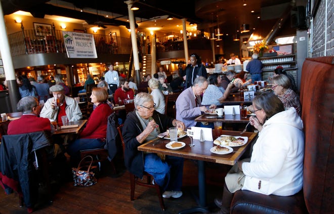 Dozens of guests seated at tables enjoy a traditional Thanksgiving meal at the annual Thanksgiving feast held at Chuck's Fish in downtown Tuscaloosa on Thursday, Nov. 23, 2017. [Staff file photo]