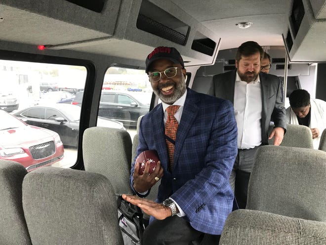 Memphis City Council Chairman Martavius Jones does the Heisman pose on a city of Memphis bus Tuesday, Nov. 15. The football in his hand was  a Memphis Showboats branded football.