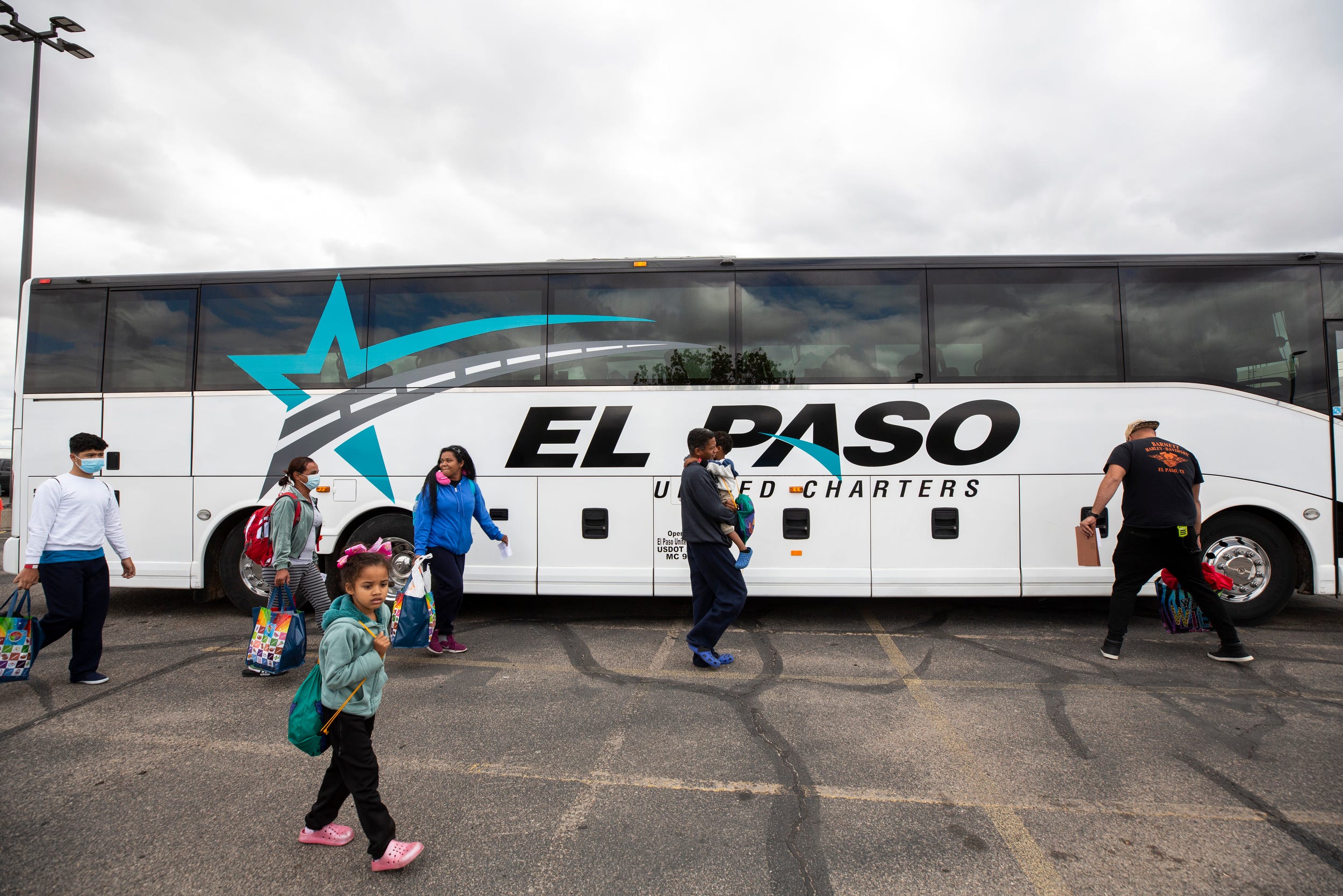 Kristian Gonzalez Perez, his wife Katiuska Carolina Leal Moreno and their two children get ready to board a bus headed to New York City from the Migrant Welcome Center in El Paso, Texas.