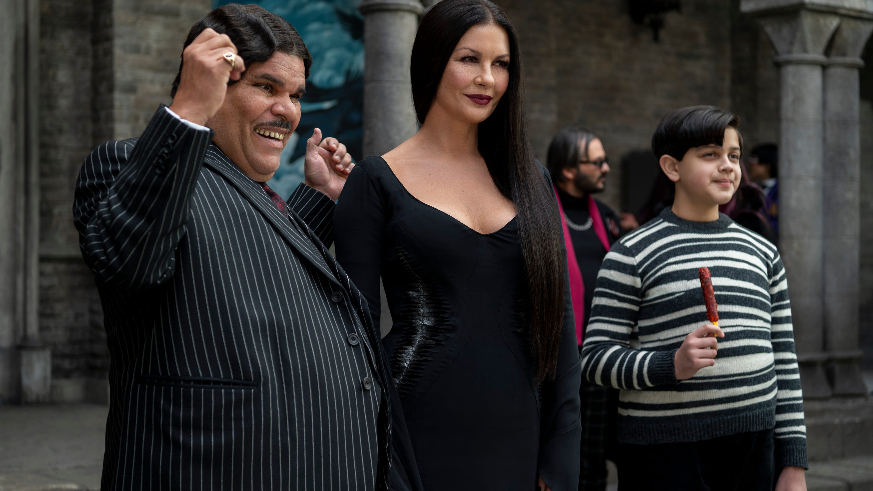 The rest of the Addams family: Luis Guzmán as Gomez Addams, Catherine Zeta-Jones as Morticia Addams and Issac Ordonez as Pugsley Addams in "Wednesday."