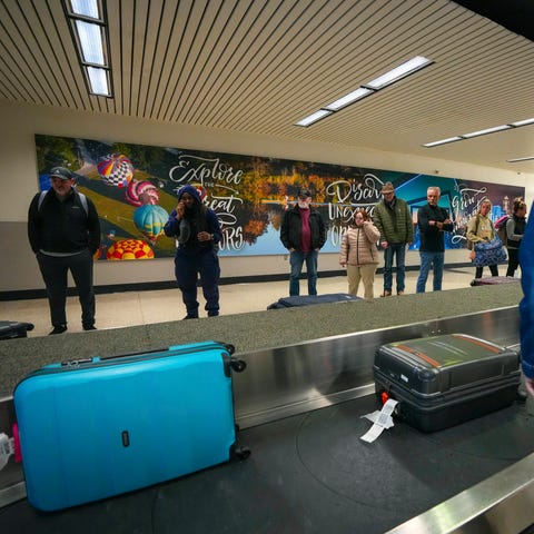 People wait for their luggage at the Des Moines In