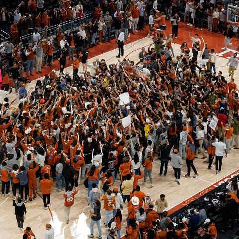 Texas fans rush the court after the Longhorns' win