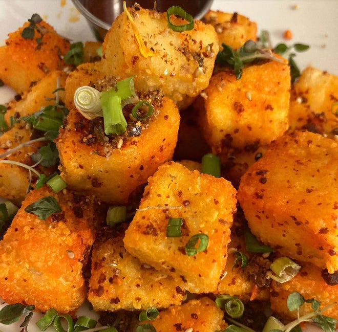 A new happy-hour menu at Tideline Ocean Resort's Brandon's includes lightly fried tofu with chili garlic, sesame seeds and green onions.