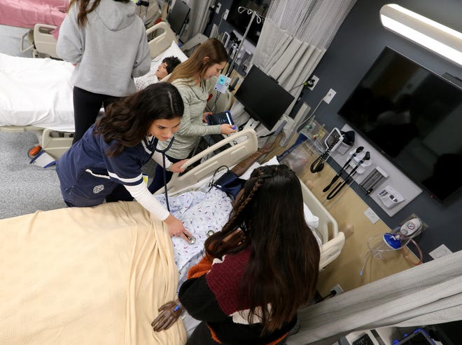 Saint Mary’s College nursing students demonstrate the clinical training they can practice Friday, Nov. 18, 2022, in the nursing lab in the Saint Mary’s Center for Healthcare Education in Regina Hall.
