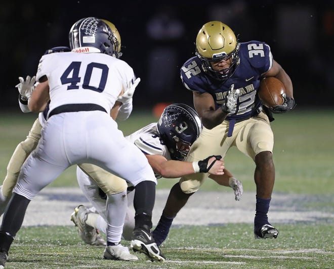 Hoban running back Lamar Sperling, right, breaks away from Hudson linebacker Blake Toth during the first half of a Division II regional championship football game, Friday, Nov. 18, 2022, in Twinsburg, Ohio.
