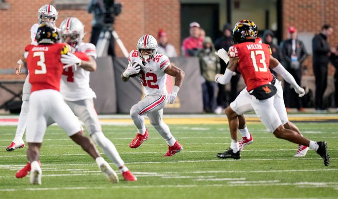 Nov 19, 2022; College Park, MD, USA; Ohio State Buckeyes running back TreVeyon Henderson (32) carries the ball against Maryland Terrapins in the second quarter of their Big Ten game at SECU Stadium. 
