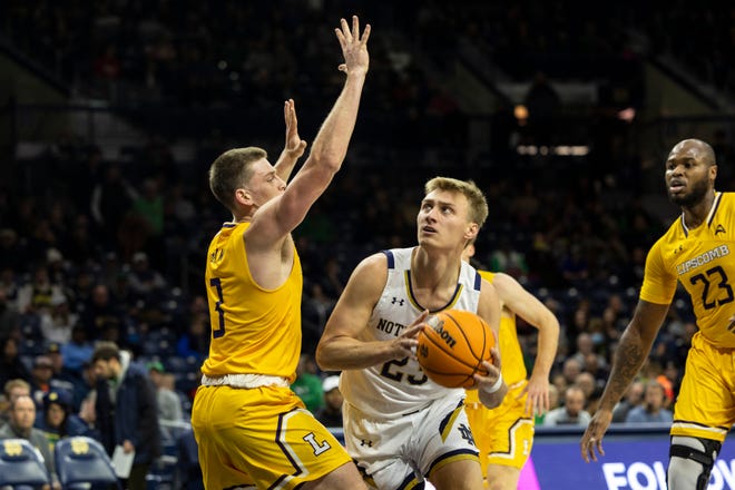 Notre Dame guard Dane Goodwin (23) drives to the basket as Lipscomb guard Trae Benham (3) defends during the Lipscomb-Notre Dame NCAA Men’s basketball game on Friday, November 18, 2022, at Purcell Pavilion in South Bend, Indiana.