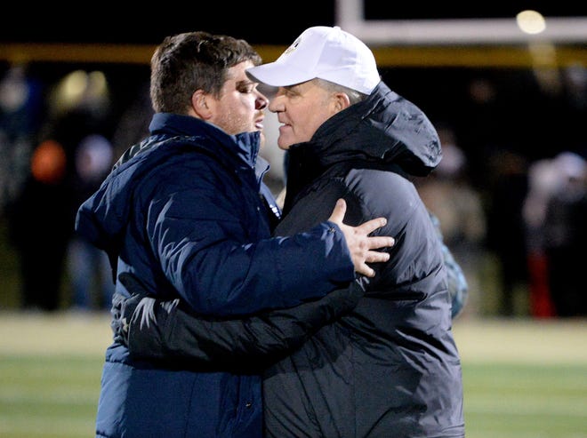 Rochester Coach Derek Leonard, left, gives the Sacred Heart-Griffin coach, and his dad, Ken Leonard, a hug at the conclusion of the game Friday. Nov. 18. 2022.