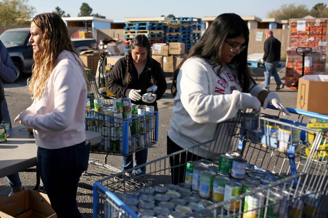 Arrowhead Park Early College High School students assemble Thanksgiving baskets on Saturday, Nov. 19, 2022, at Casa de Peregrinos. The baskets will be given away Monday.