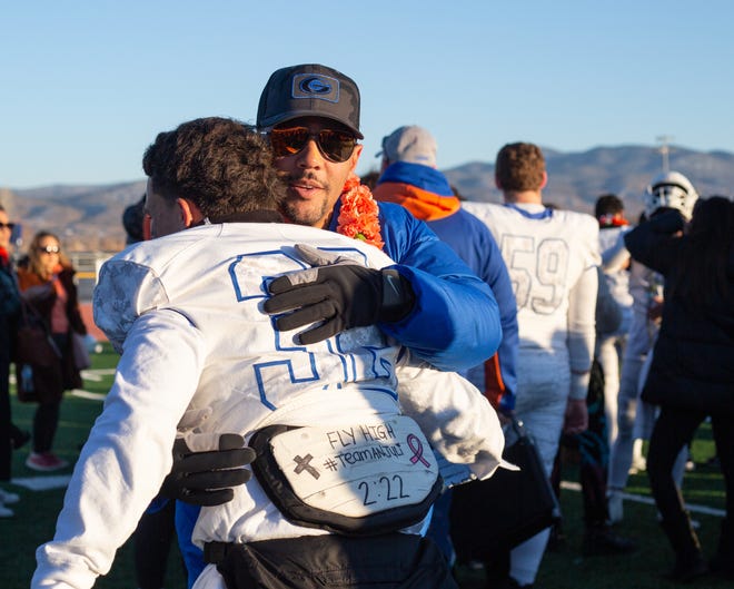 Bishop Gorman coach Brett Browner hugs a player after winning the state championship against Bishop Manogue at Carson High School on Nov. 19, 2022.
