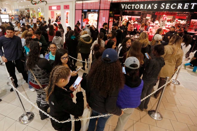 Shoppers queue up in front of Victoria's Secret on Black Friday, in Dartmouth, Mass., in 2016.