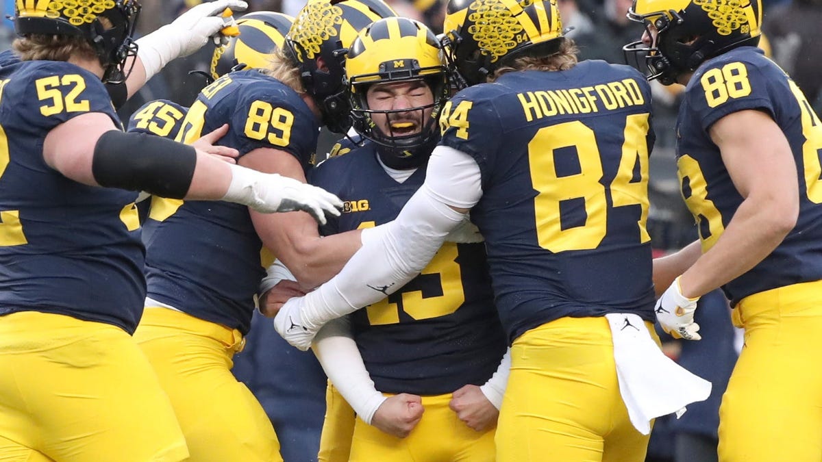 Michigan kicker Jake Moody (13) celebrates with tight end Joel Honigford and other teammates after Moody kicked the winning field goal against Illinois at Michigan Stadium, Saturday, Nov. 19, 2022.