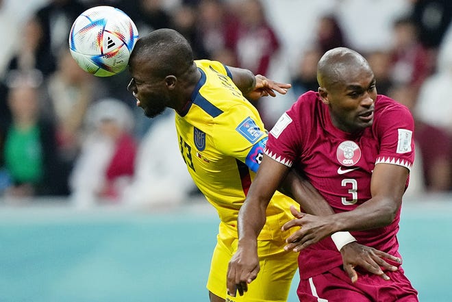 Ecuador forward Enner Valencia (13) battles for a header against Qatar defender Abdelkarim Hassan (3) during the 2022 FIFA World Cup at Al Bayt Stadium.