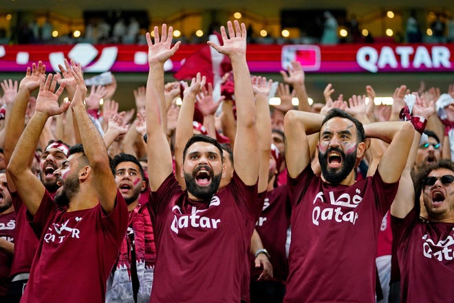 Fans cheer before a group stage match during the 2022 FIFA World Cup between Qatar and Ecuador at Al Bayt Stadium on Nov. 20.