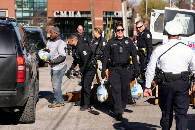Columbus police distribute Thanksgiving turkeys on Monday at a drive-through line behind the South Linden precinct station. Police gave out more than 700 turkeys at six locations across Columbus, including the Downtown headquarters.